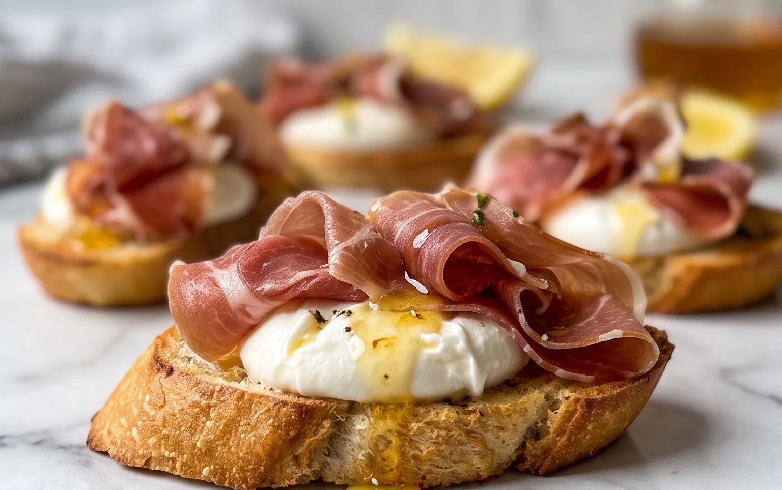 Beef Prosciutto Crostini with Burrata and Lemon Honey Drizzle